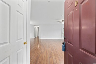 Entryway with wood-type flooring and ceiling fan