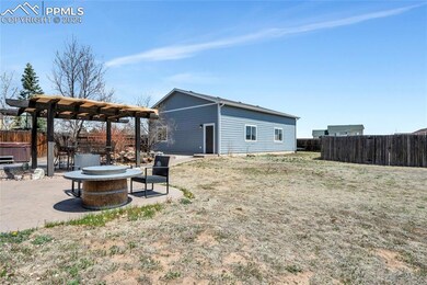 View of yard with a patio, a fire pit, and a pergo