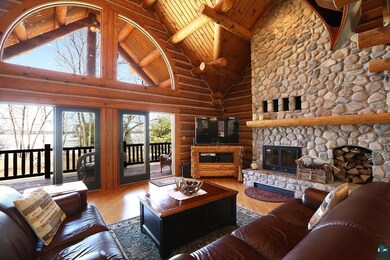 Living room with log walls, high vaulted ceiling, 