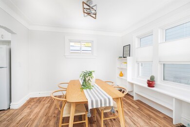 Dining space featuring ornamental molding and ligh