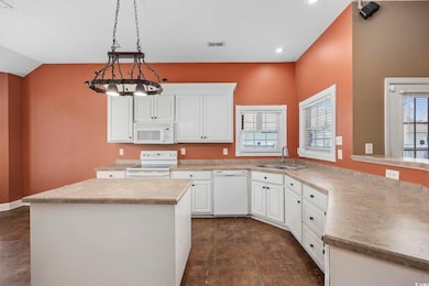 Kitchen featuring visible vents, light countertops