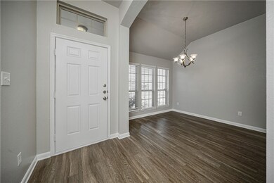 Entryway with baseboards, dark wood-style flooring