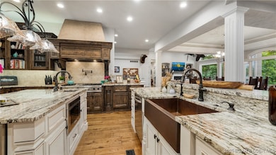 The gourmet kitchen features a hammered copper sin