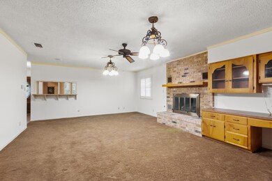 Unfurnished living room featuring a chandelier, c