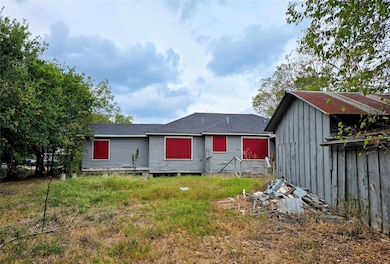 Rear view of house featuring roof with shingles