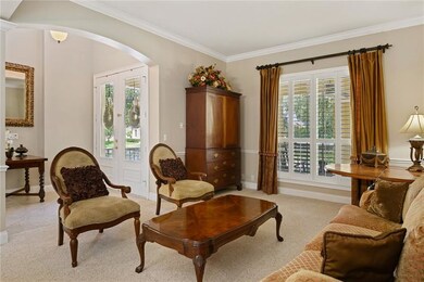 Living Room features crown molding and plantation 