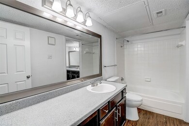 Full bathroom featuring toilet, tiled shower / bat