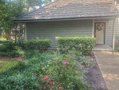 View of side of property featuring roof with shingles and a chimney