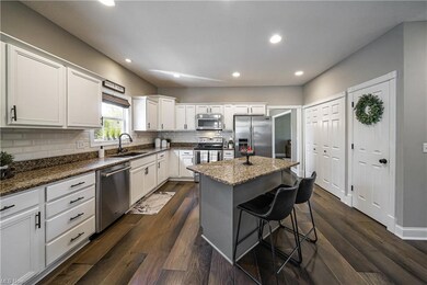 Kitchen with a kitchen island, white cabinetry, st