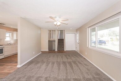 Unfurnished living room with hardwood flooring, si