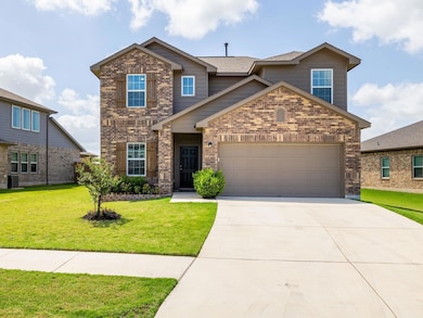 Traditional home featuring brick siding, a garage