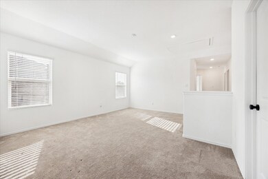 Carpeted spare room with recessed lighting and ba