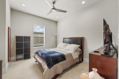 This cozy bedroom features neutral walls, a comfor