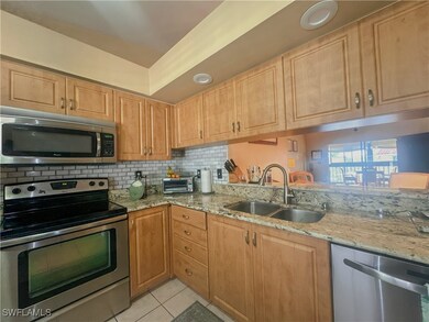 Kitchen with tasteful backsplash, appliances with
