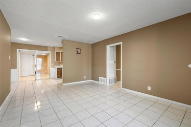 Spare room featuring a textured ceiling and light