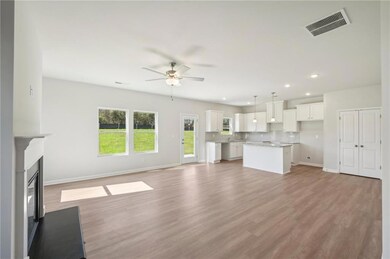 Unfurnished living room with baseboards, a ceiling fan, recessed lighting, light wood finished floors, and a glass covered fireplace