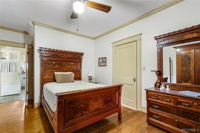 Bedroom featuring 
 wood flooring, crown molding,