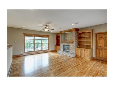 Newly finished hardwoods, brick fireplace, and bea