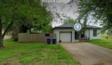 Ranch-style house with a garage and a front yard