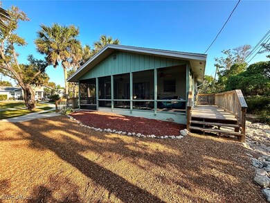 Rear view of property featuring a sunroom, ceiling