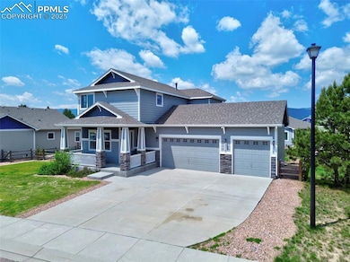 Craftsman-style home featuring a garage, covered porch, driveway, stone siding, and a shingled roof