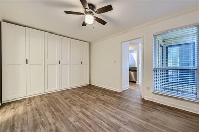 Unfurnished bedroom featuring ceiling fan, crown m