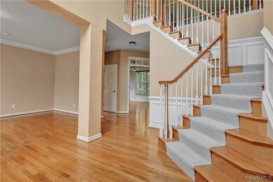 Foyer with Hardwood Floors, Wood Stairs, Two Story