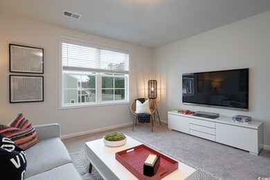 Living room featuring visible vents, carpet floori