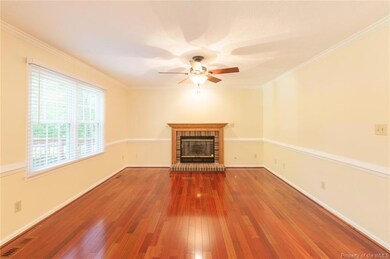 Spacious family room has crown molding, chair rails and wood or gas burning fireplace.