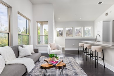 Living area with baseboards, visible vents, vault