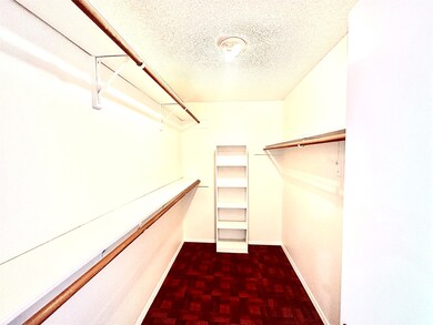 Walk in closet of 2nd flr bedroom.