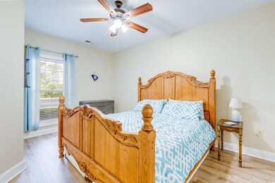 Bedroom with hardwood / wood-style flooring and ce
