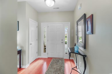 Entrance foyer with wood finished floors and baseboards