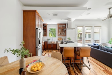 Kitchen featuring glass insert cabinets, open flo