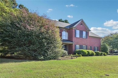 View of front of property featuring a front yard and brick siding