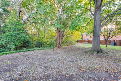 View of park-like front yard and creek