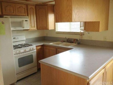 Remodeled kitchen has beautiful oak cabinets and e