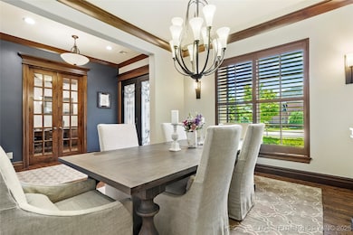 Dining space with wood finished floors, a chandeli