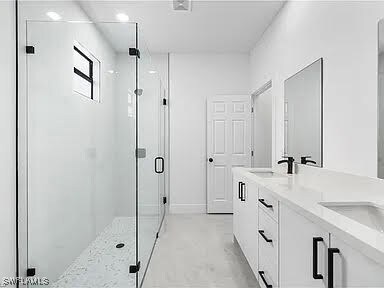 Bathroom with a shower with door and vanity