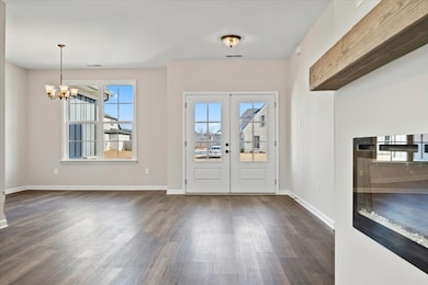 Foyer featuring a notable chandelier, french doors