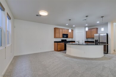 Kitchen, brown cabinets, stainless steel fridge,an