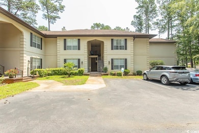 Townhome / multi-family property with uncovered parking and a chimney