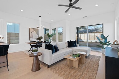 Living area with recessed lighting and light wood