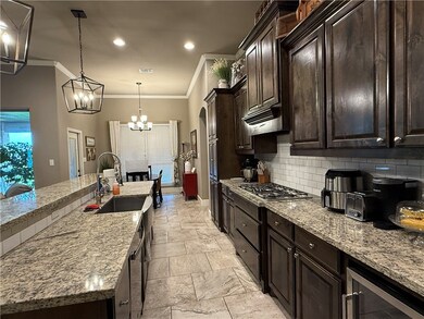 Kitchen with tasteful backsplash, crown molding, l