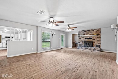 Unfurnished living room featuring hardwood / wood-