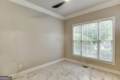 Front office with oversized windows and granite flooring offers a quiet workspace near the entry.