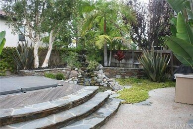 View of in ground Jacuzzi and Koi pond with waterf