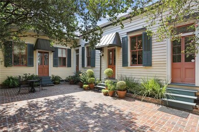 Old brick courtyard frames the primary bedroom on