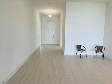 Hallway with light wood finished floors