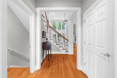 Hallway featuring light wood finished floors and stairs